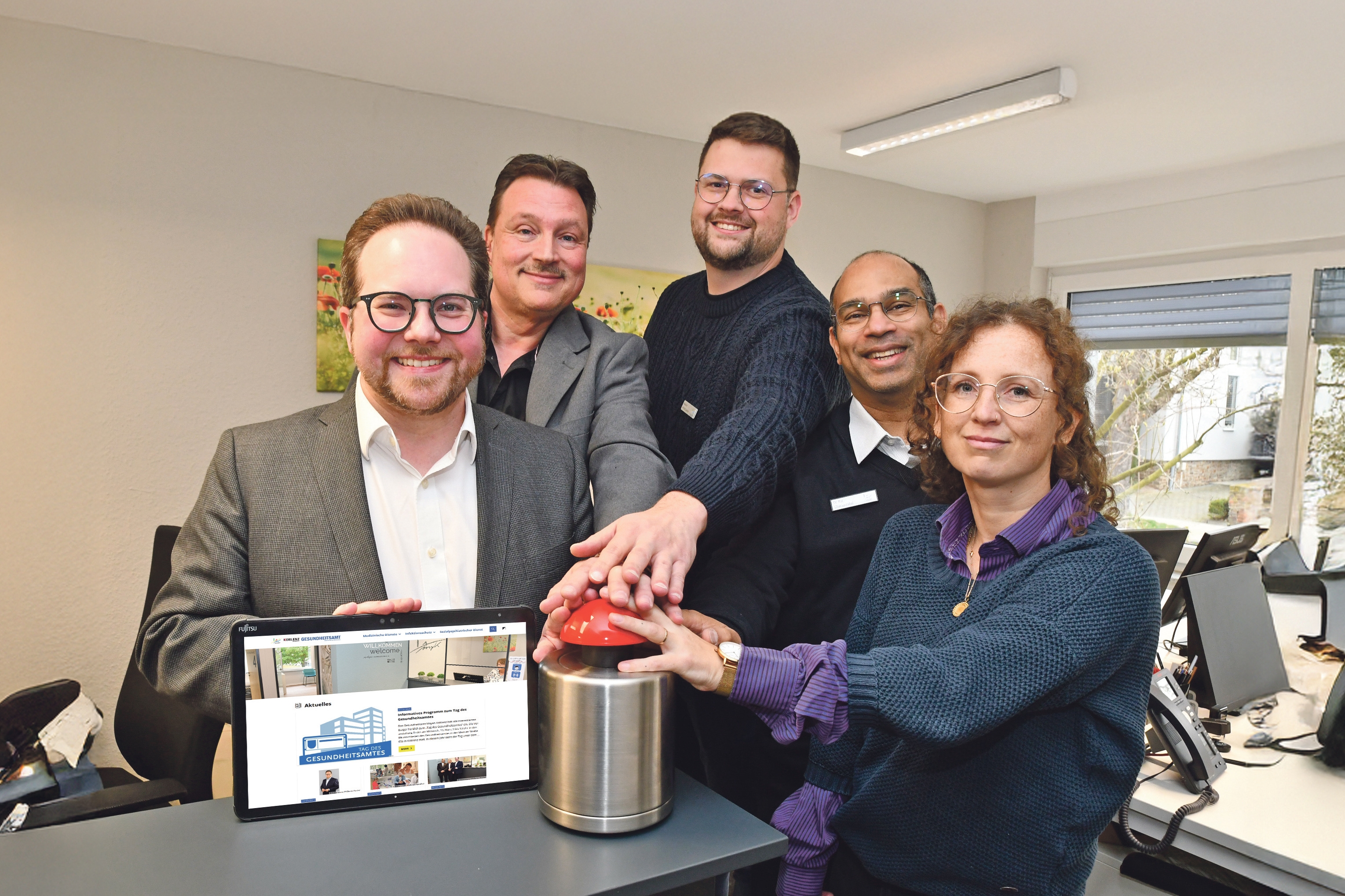 Der Erste Kreisbeigeordnete Pascal Badziong (links im Bild), hat gemeinsam mit dem Ärztlichen Leiter des Gesundheitsamtes Dr. Raj Chakupurakal (2.v.r.), dem Verwaltungsleiter Oliver Michels (2.v.l.) sowie den GA-Mitarbeitenden Johanna Braun und Marco Venetsanos, die sich unter anderem um die Umsetzung des Webauftritts gekümmert haben, den Startknopf für die neue Internetseite gedrückt.  