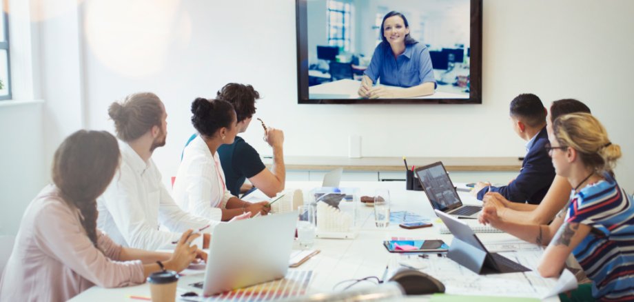 Designers video conferencing in conference room meeting Designers video conferencing in conference room meeting